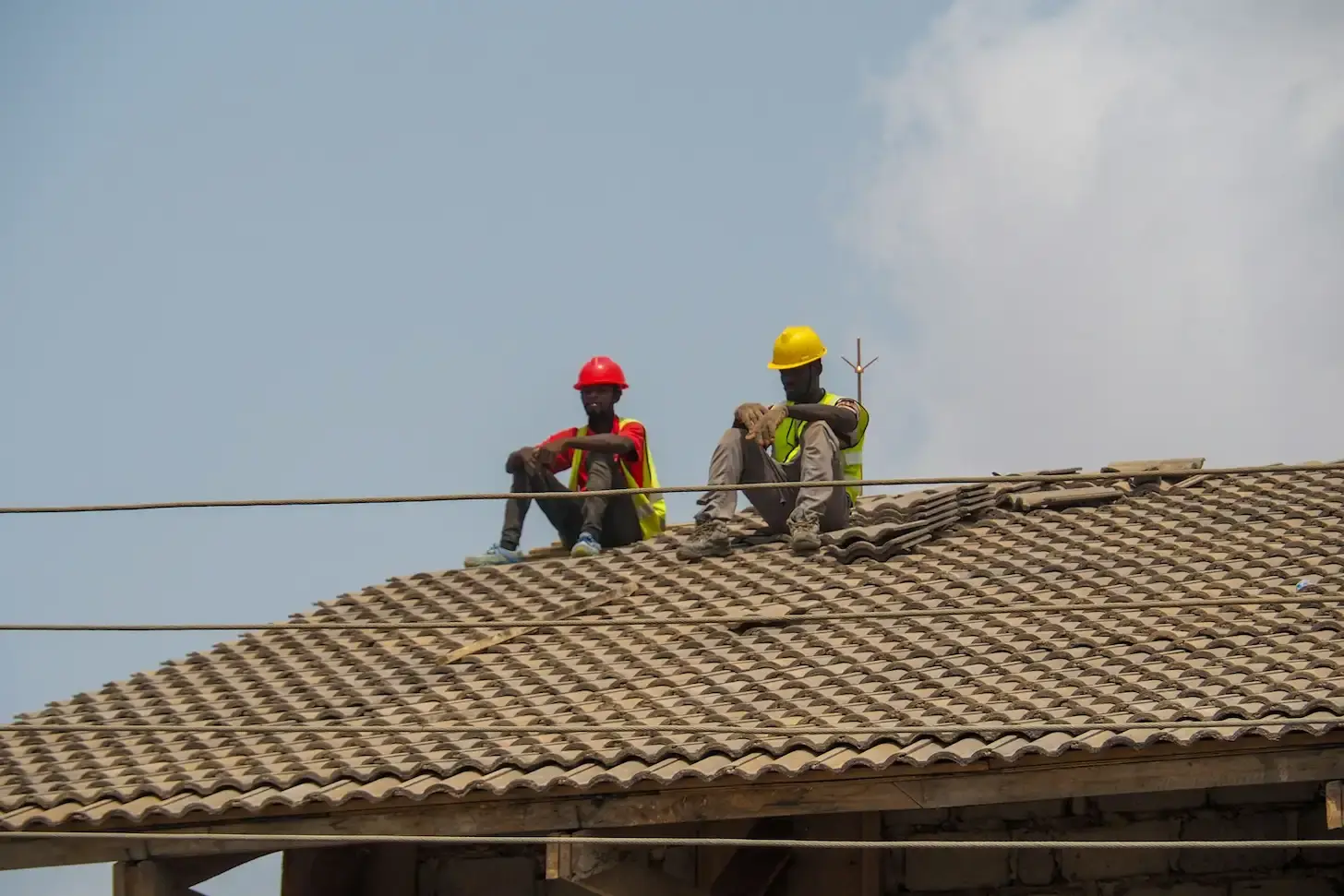 professional team on repair of roof shingles